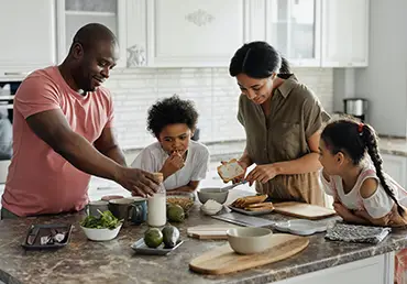 A family enjoys making breakfast together.